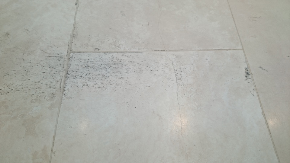 Marks to the incorrect seal on a travertine tiled floor